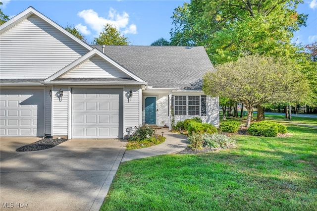 view of front of home with a garage, a shingled roof, a front lawn, and concrete driveway