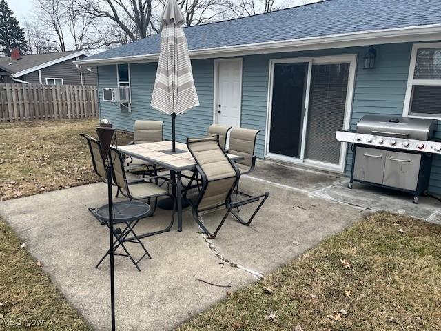 view of patio / terrace featuring outdoor dining space, cooling unit, a grill, and fence