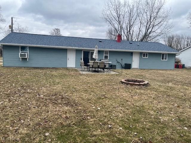 rear view of property featuring an outdoor fire pit, cooling unit, a patio, and a chimney