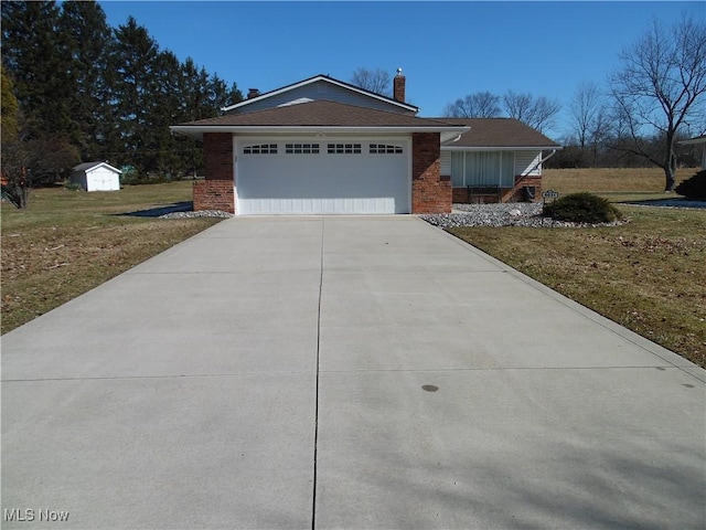 single story home featuring brick siding, a chimney, concrete driveway, an attached garage, and a front lawn