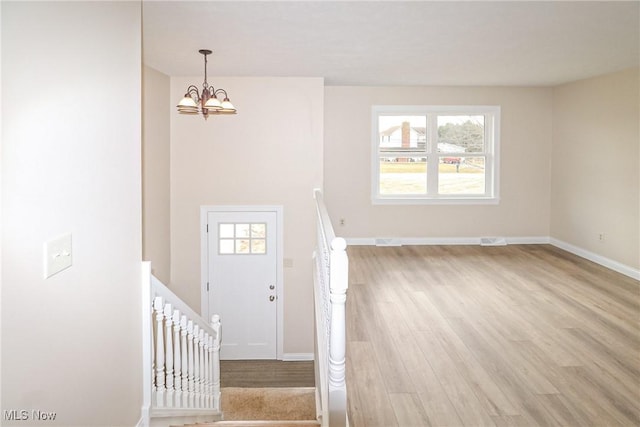 757 Eastern Rd, Doylestown, OH 44230 - foyer entrance with light wood finished floors, baseboards, a chandelier, and visible vents