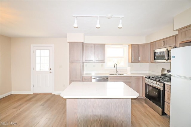 757 Eastern Rd, Doylestown, OH 44230 - kitchen featuring stainless steel appliances, light countertops, a sink, light wood-style floors, and a center island
