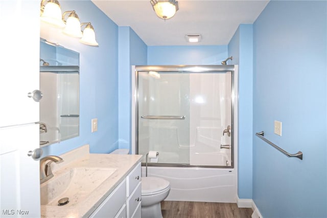 757 Eastern Rd, Doylestown, OH 44230 - bathroom with shower / bath combination with glass door, wood finished floors, toilet, vanity, and baseboards