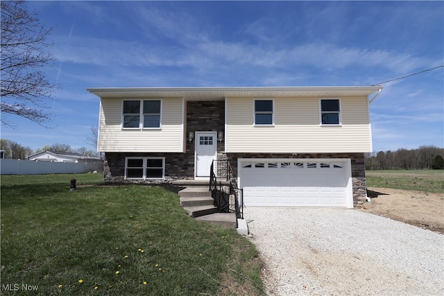 757 Eastern Rd, Doylestown, OH 44230 - split foyer home featuring stone siding, a front lawn, driveway, and a garage