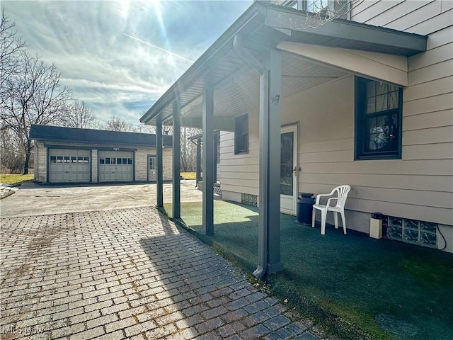 view of property exterior with a garage and an outbuilding