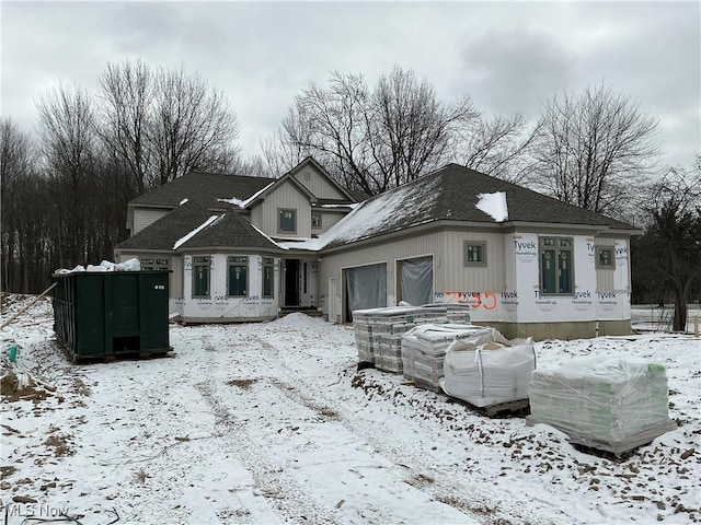 view of snow covered back of property