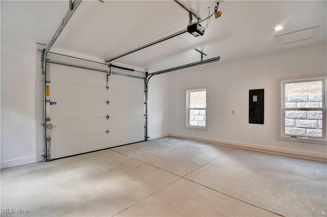 garage with electric panel, baseboards, and a garage door opener