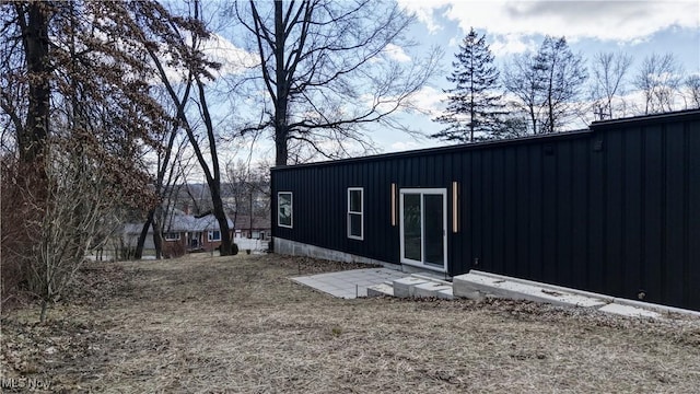 rear view of house featuring board and batten siding