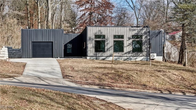 view of front of property with a garage and concrete driveway