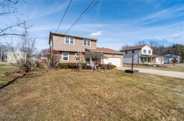 view of front of house featuring a garage, a front yard, and driveway