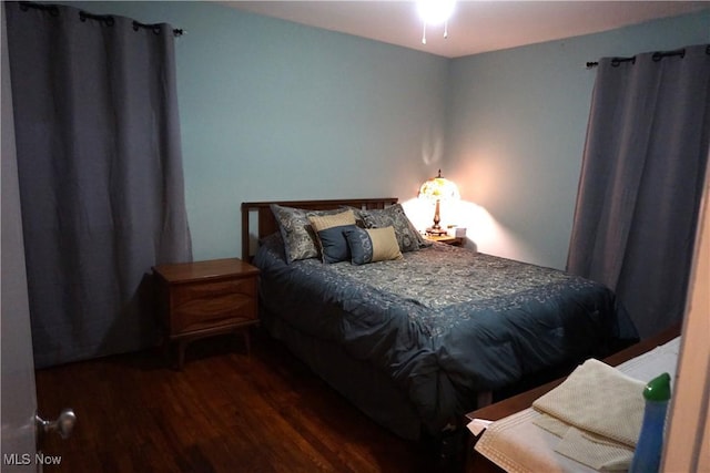 bedroom featuring dark wood finished floors