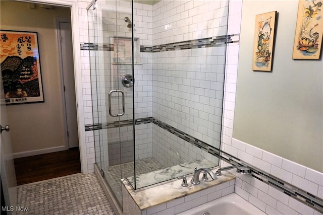 full bath with a shower stall