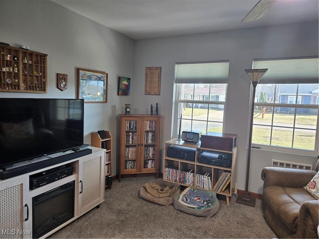 carpeted living area featuring baseboards and visible vents