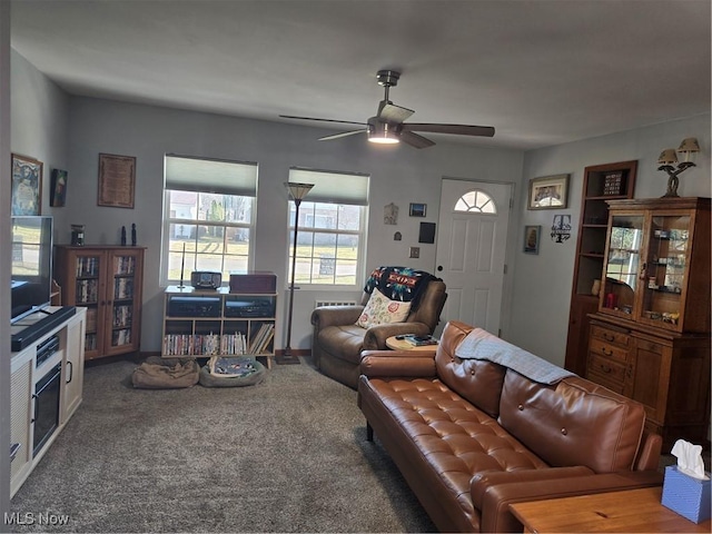 carpeted living room with a ceiling fan