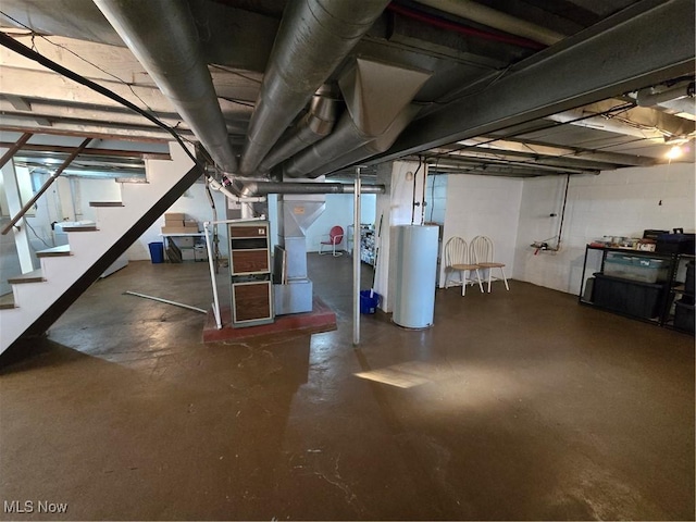 unfinished below grade area featuring gas water heater and stairway