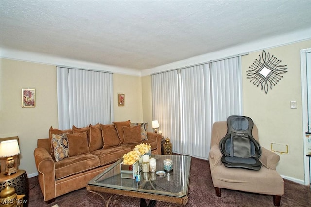 carpeted living room featuring a textured ceiling and baseboards