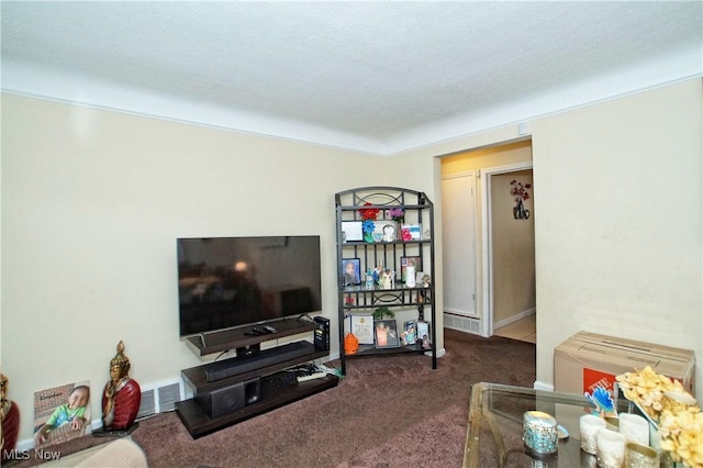 carpeted living room with visible vents and a textured ceiling