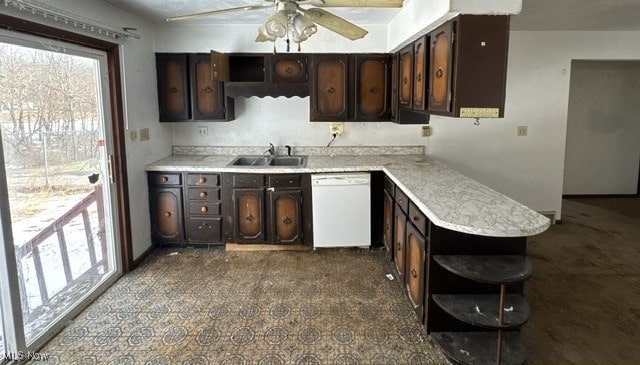 kitchen featuring dark brown cabinetry, white dishwasher, open shelves, and a sink