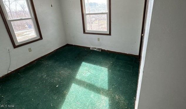 empty room with a wealth of natural light and visible vents