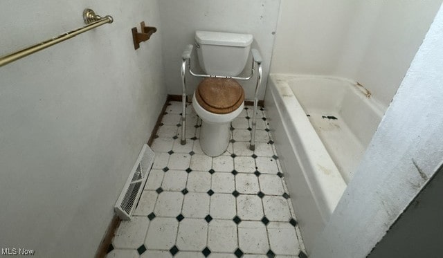 bathroom with toilet, a bathtub, visible vents, and tile patterned floors