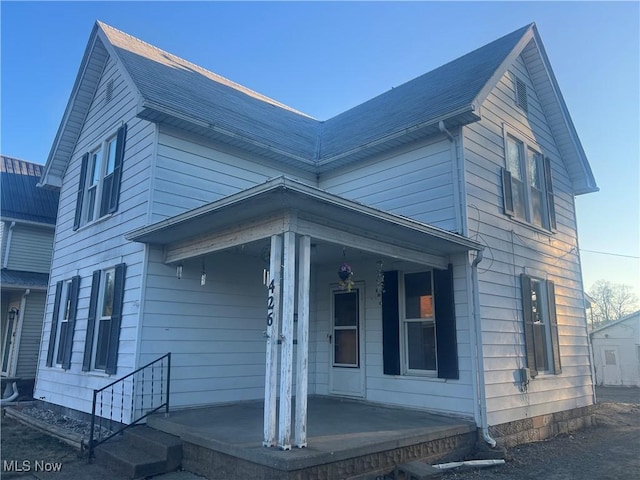 view of side of home with a porch