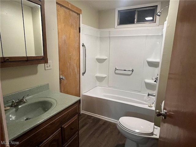 full bathroom with toilet, vanity, wood finished floors, and bathing tub / shower combination