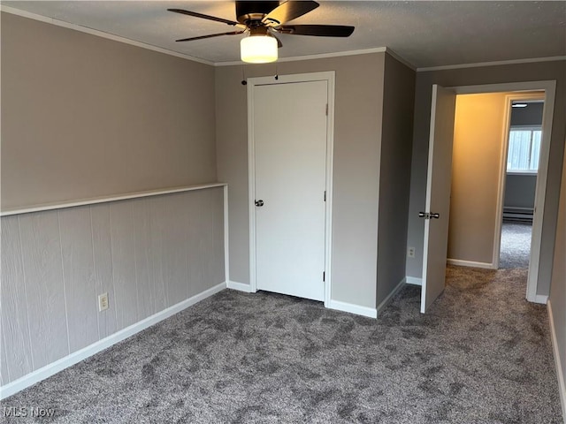 unfurnished bedroom featuring ceiling fan, carpet floors, ornamental molding, and a baseboard radiator