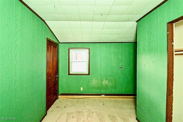 empty room featuring lofted ceiling