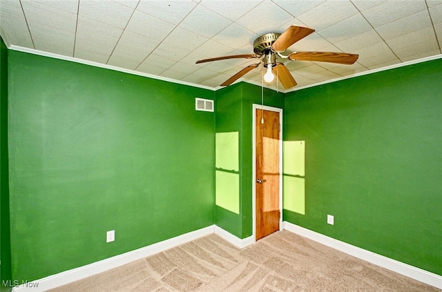 unfurnished bedroom featuring baseboards, carpet floors, visible vents, and crown molding