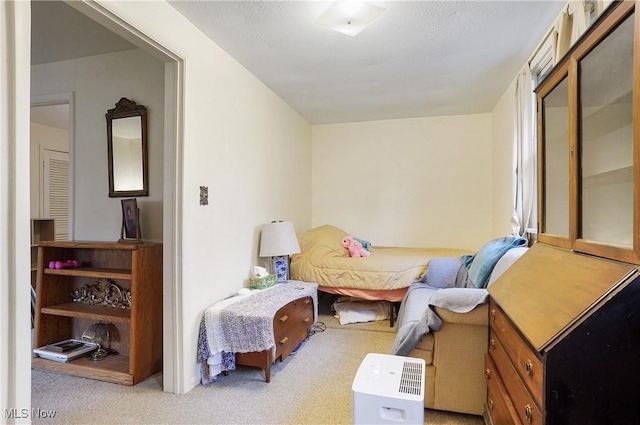 bedroom featuring light carpet