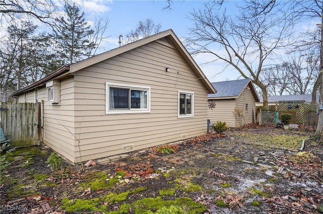 view of side of property featuring fence