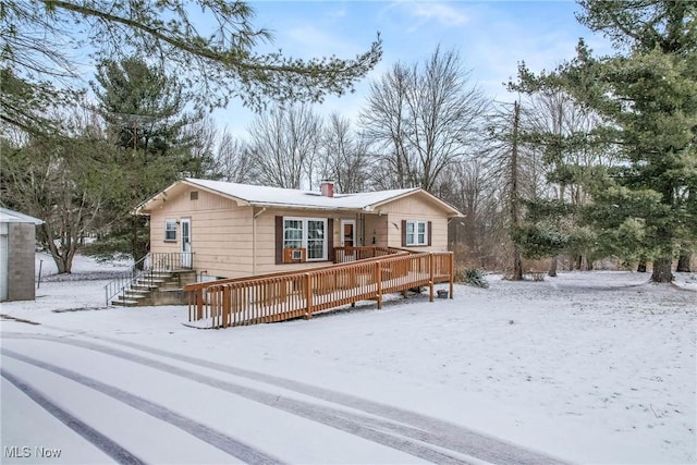 view of front of home featuring a chimney and a wooden deck