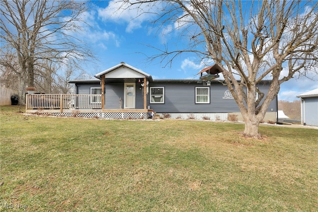 view of front of property with a deck and a front lawn