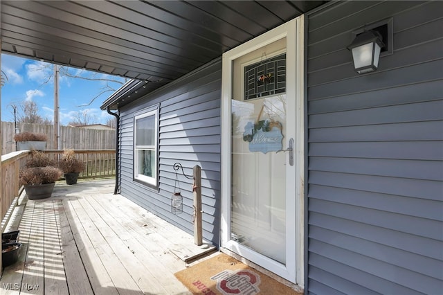 wooden terrace with a porch and fence