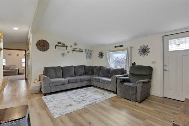 living room with lofted ceiling and light wood finished floors