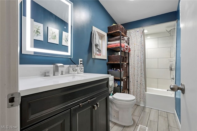 full bathroom featuring shower / bath combo, visible vents, toilet, wood tiled floor, and vanity