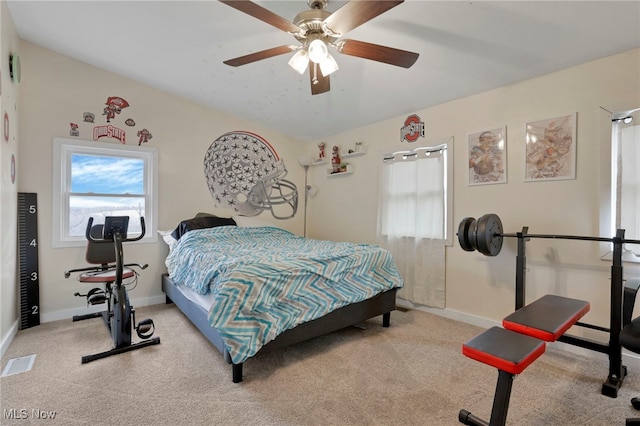 bedroom featuring lofted ceiling, carpet flooring, and multiple windows