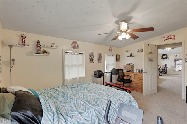 bedroom with lofted ceiling, a ceiling fan, and light colored carpet