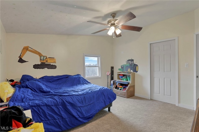 carpeted bedroom with ceiling fan, lofted ceiling, and baseboards