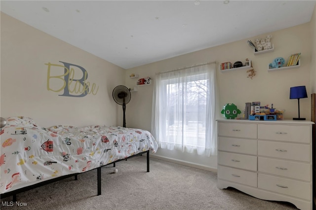 bedroom with baseboards and light colored carpet