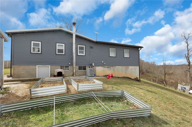 back of house featuring a vegetable garden, cooling unit, and a yard