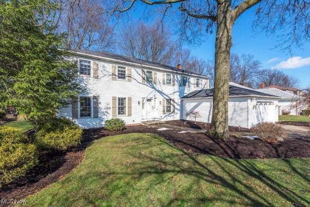 colonial inspired home featuring a chimney and a front yard