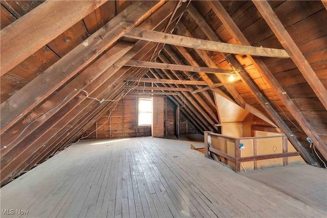 unfinished attic featuring an upstairs landing