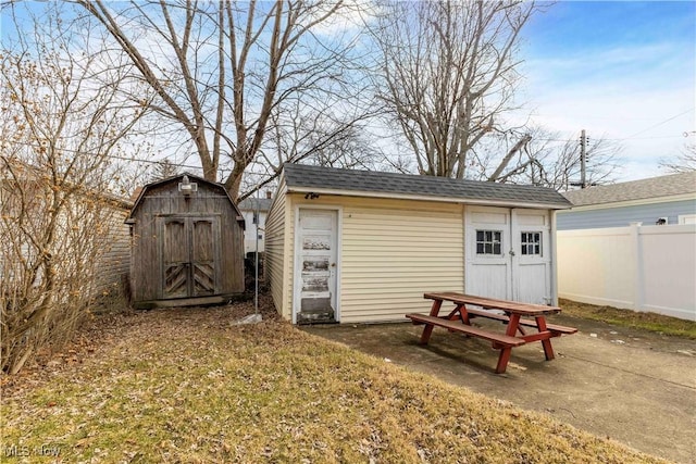 view of shed with fence