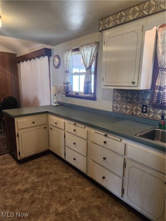 kitchen with dark countertops and a sink