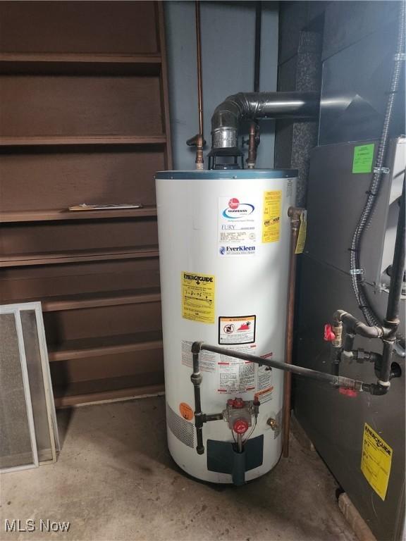 utility room featuring water heater and heating unit