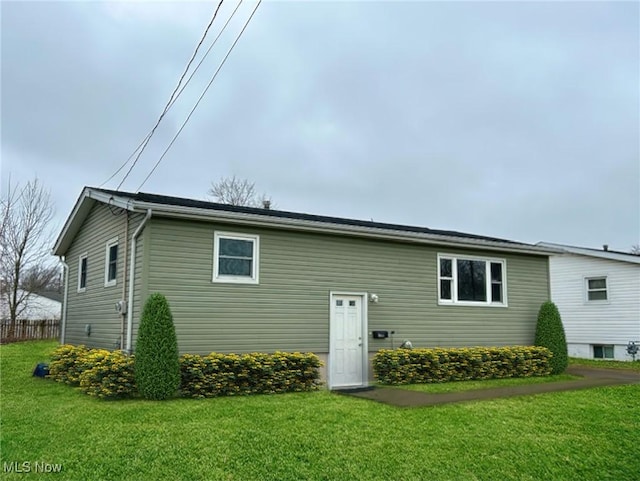 rear view of house featuring a yard