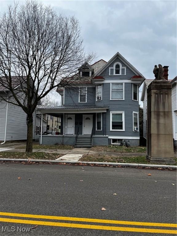 victorian-style house featuring a porch