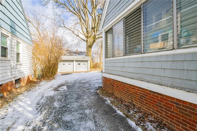 view of home's exterior with a detached garage and an outbuilding