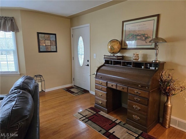 entryway featuring light wood finished floors, visible vents, and baseboards